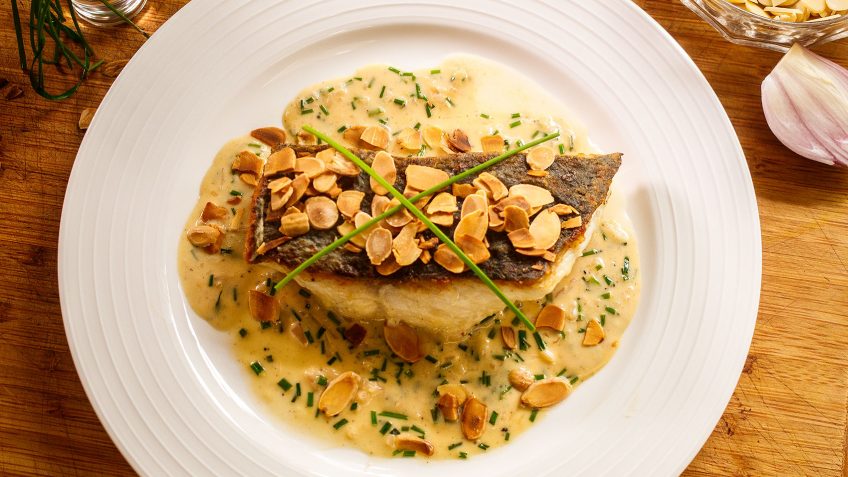 Crispy skin fish almondine with cream sherry sauce and crunchy almonds